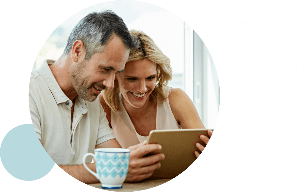 man and woman with coffee looking at website